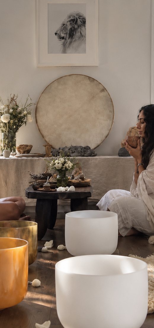 A sound bath laid out with crystal singing bowls in a sunlit room